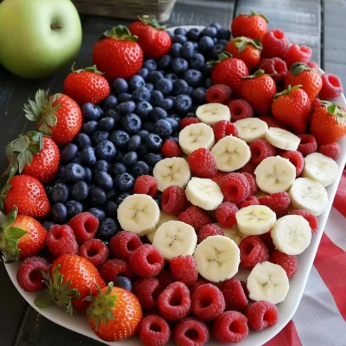 4th of July fruit platter resembling the American flag with strawberries and blueberries.