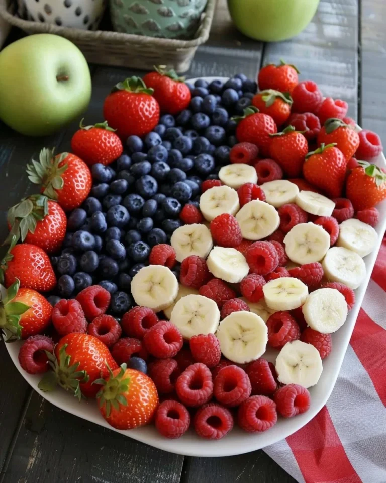 4th of July fruit platter resembling the American flag with strawberries and blueberries.