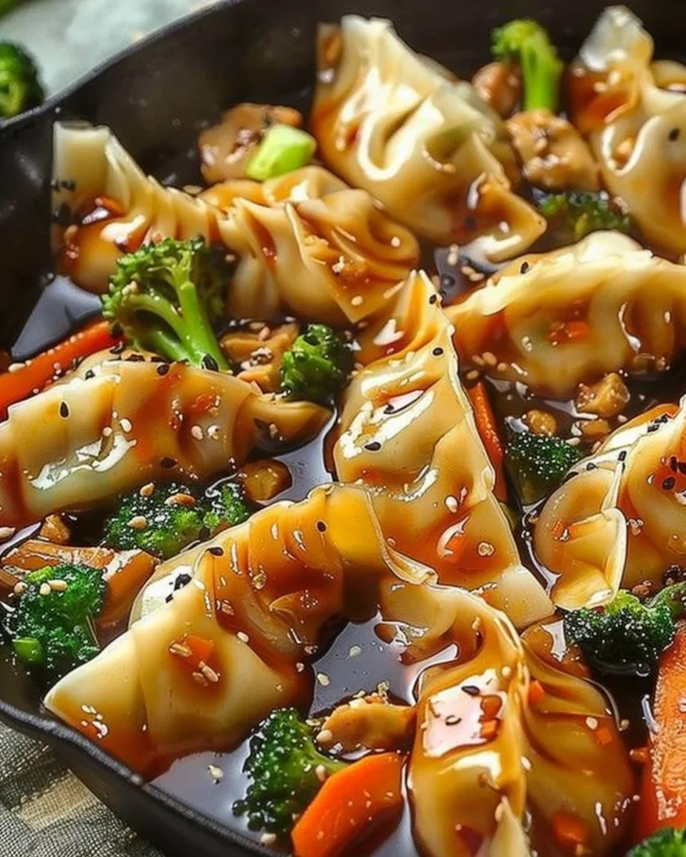 Colorful potsticker stir fry with vegetables and sauce in a skillet