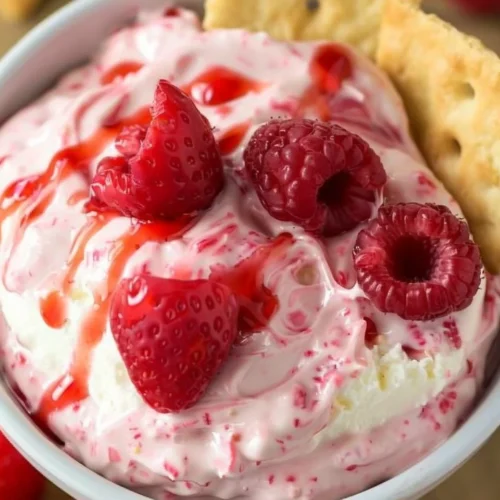 Delicious strawberry cheesecake dip served in a bowl with fresh strawberries