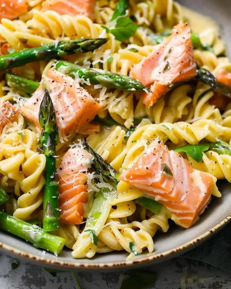 Creamy salmon pasta dish with asparagus served in a bowl