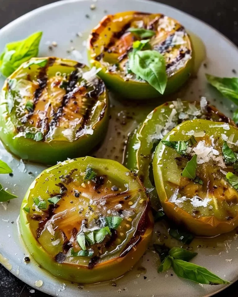 Delicious grilled green tomatoes on a plate garnished with herbs