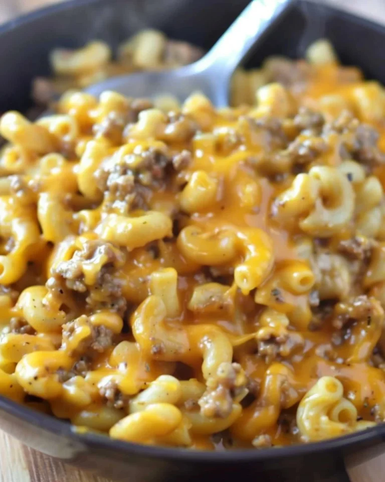 A delicious serving of homemade cheeseburger macaroni topped with cheese and herbs.