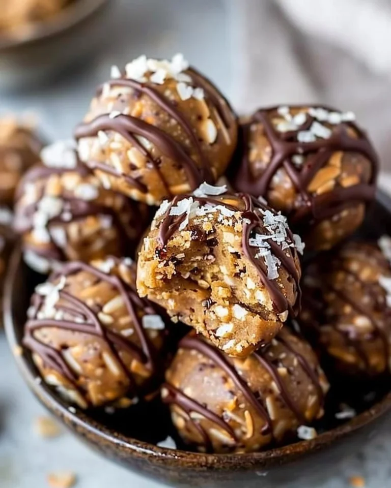 Samoa Cookie Protein Balls stacked on a plate, topped with coconut and chocolate.