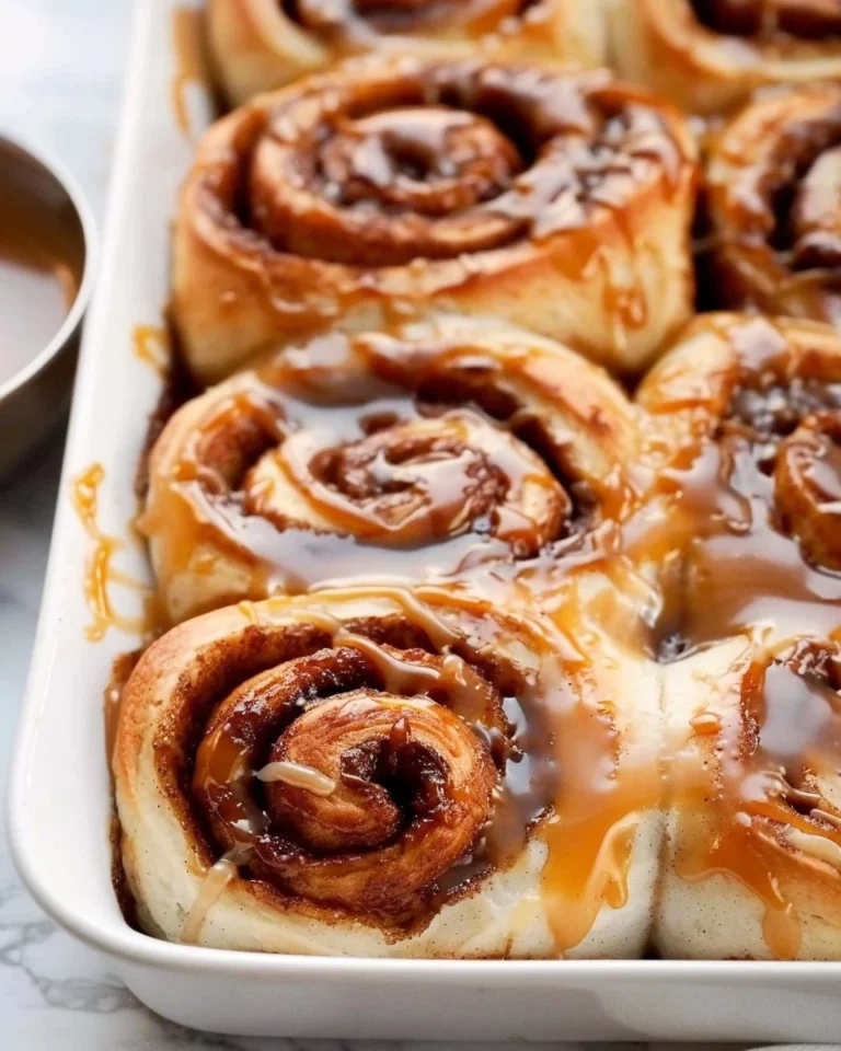 Freshly baked salted caramel cinnamon rolls topped with caramel glaze